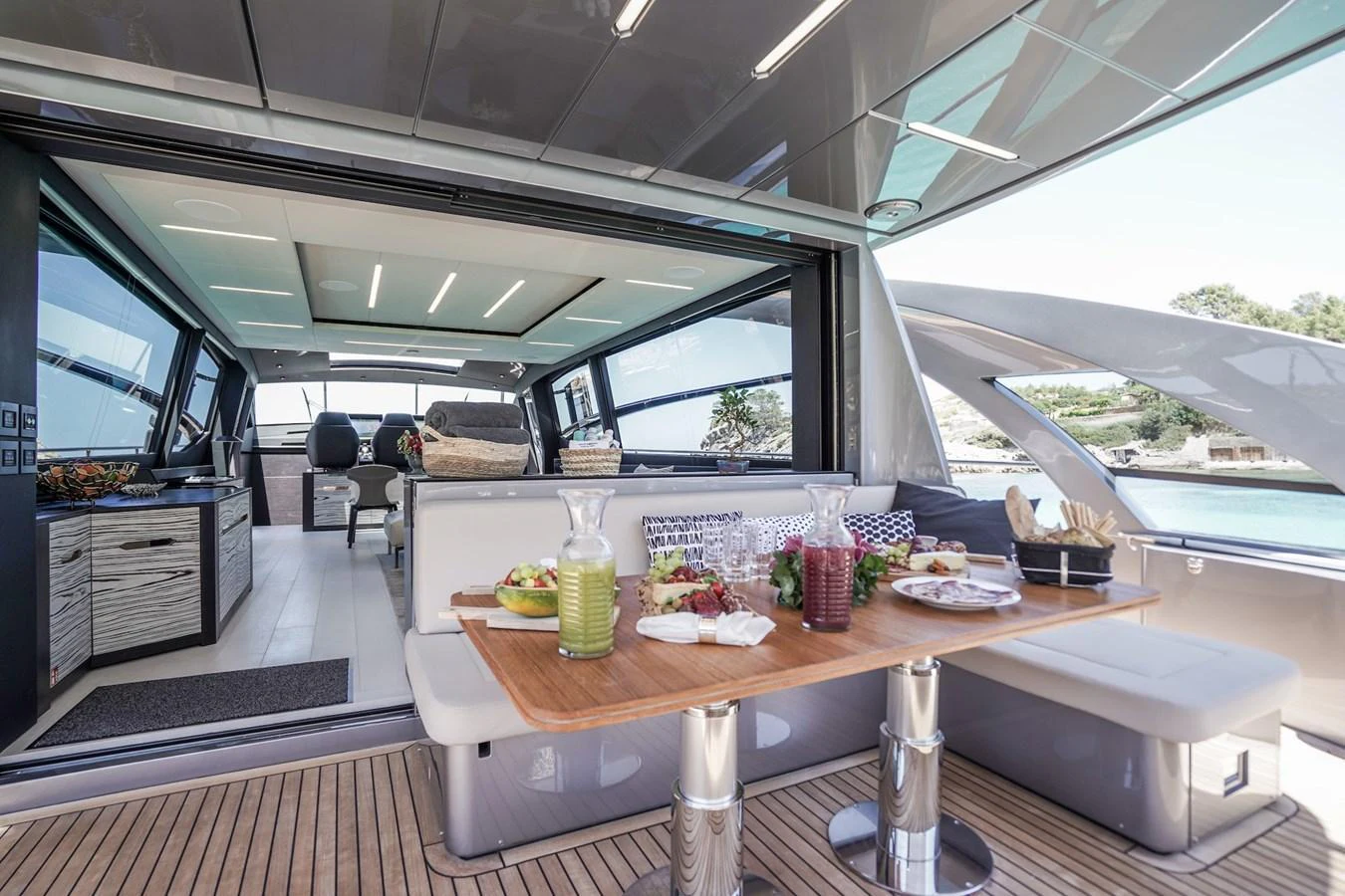 The aft deck features a stylish dining area with a seamless transition to the interior lounge. aboard DESERT STAR Yacht for Sale
