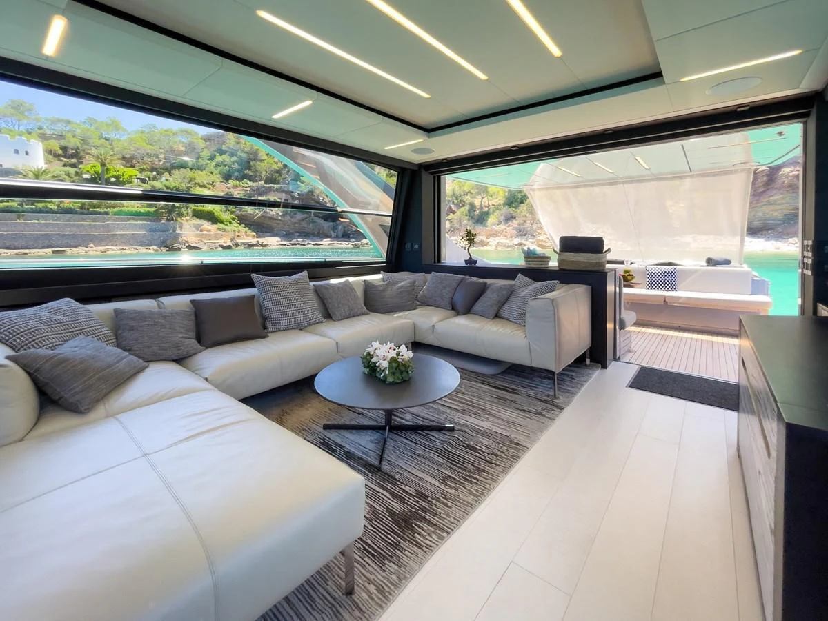 The spacious salon features a luxurious seating area with panoramic views and modern decor. aboard DESERT STAR Yacht for Sale