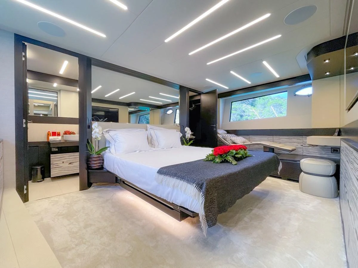 The master stateroom features a luxurious bed with elegant decor and ample natural light. aboard DESERT STAR Yacht for Sale