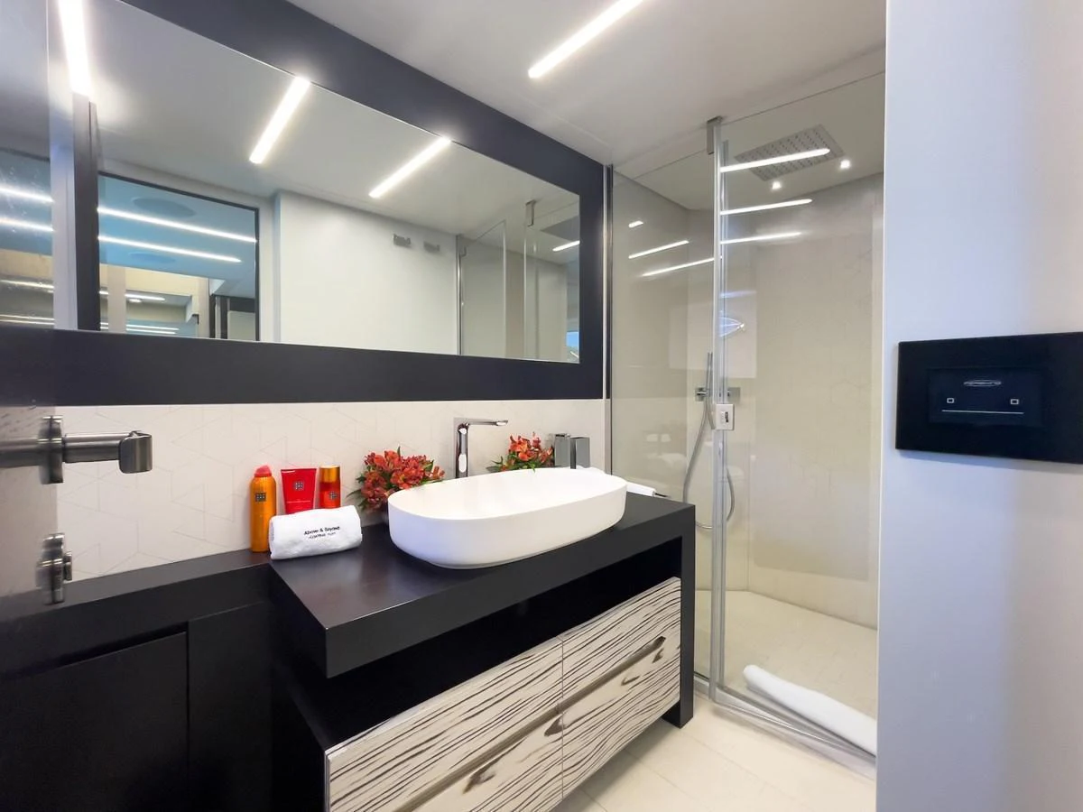 A modern and sleek bathroom with a spacious shower and elegant fixtures. aboard DESERT STAR Yacht for Sale