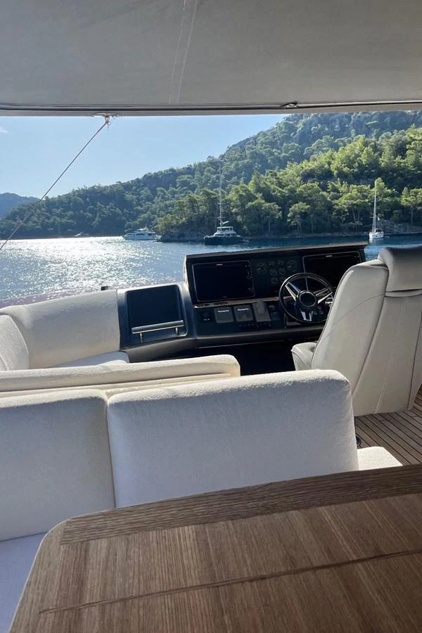 The helm area offers a commanding view of the serene waters and lush shoreline. aboard MS FELICE Yacht for Sale