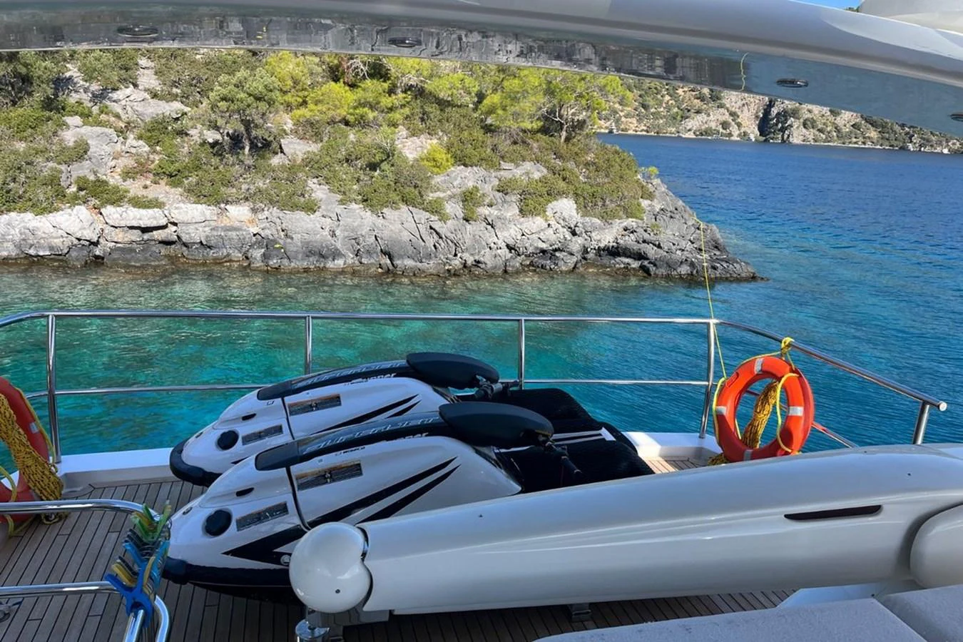 The aft deck features jet skis ready for adventure against a stunning coastal backdrop. aboard MS FELICE Yacht for Sale
