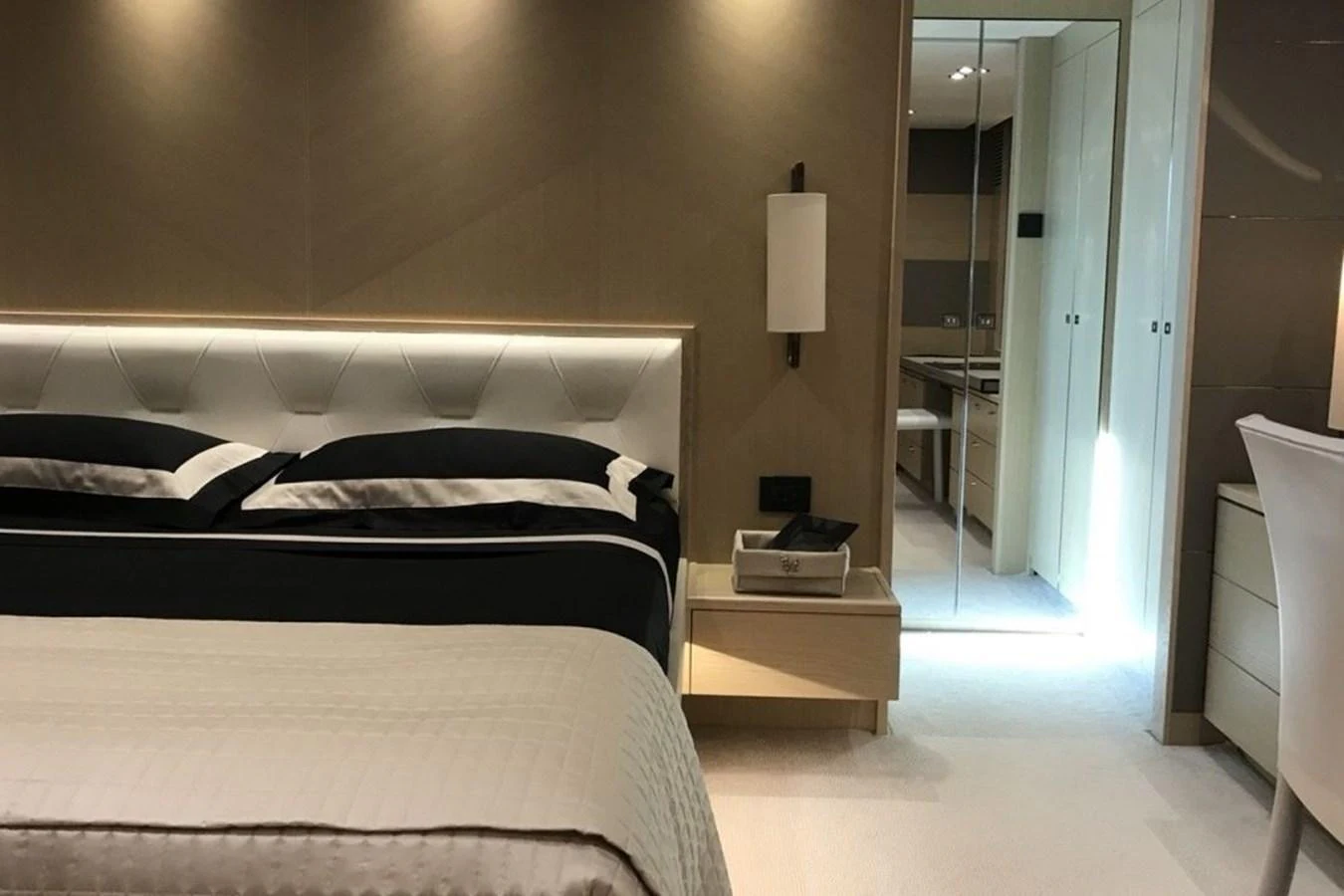 The luxurious stateroom features a comfortable bed with elegant bedding and modern lighting. aboard MS FELICE Yacht for Sale