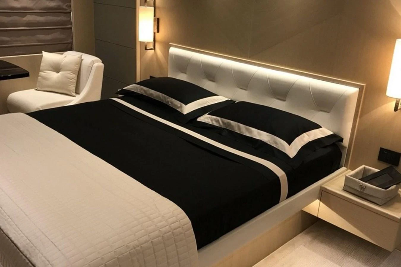 The stateroom features a luxurious double bed with elegant bedding and modern lighting. aboard MS FELICE Yacht for Sale