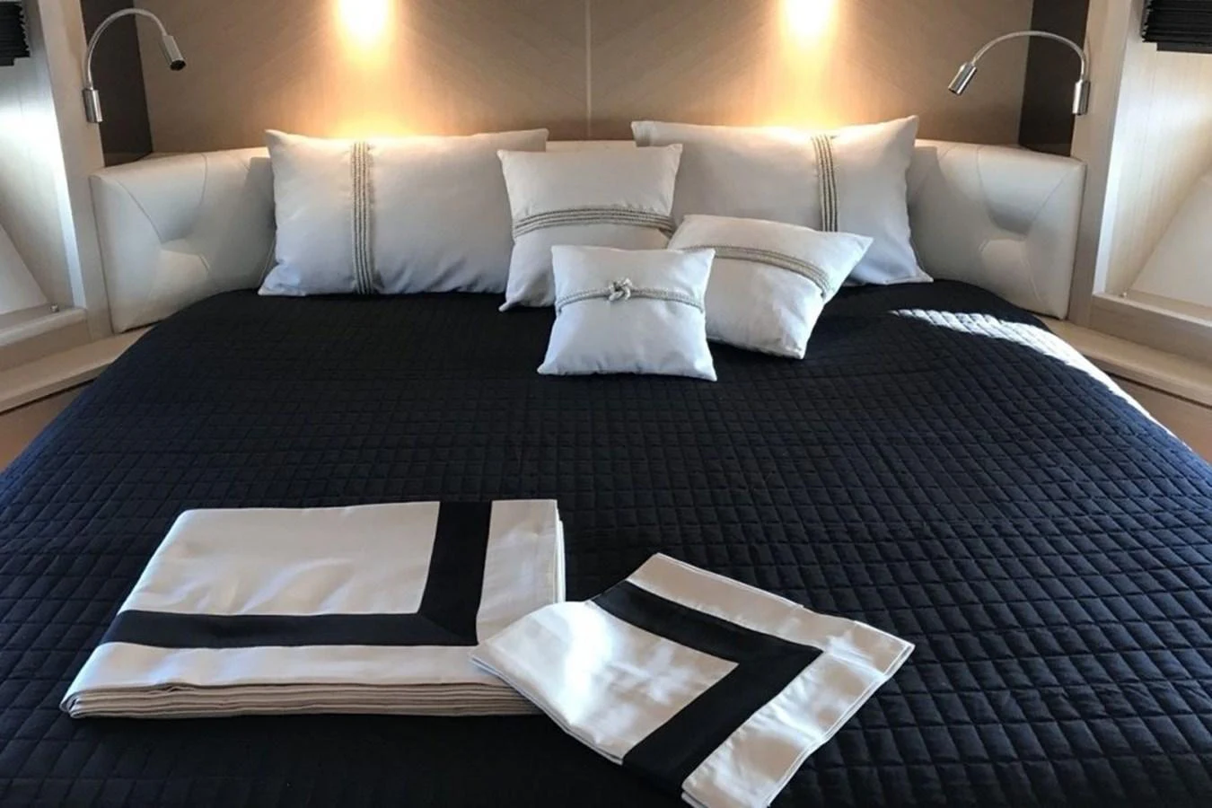 The master stateroom features a luxurious bed with elegant bedding and ambient lighting. aboard MS FELICE Yacht for Sale