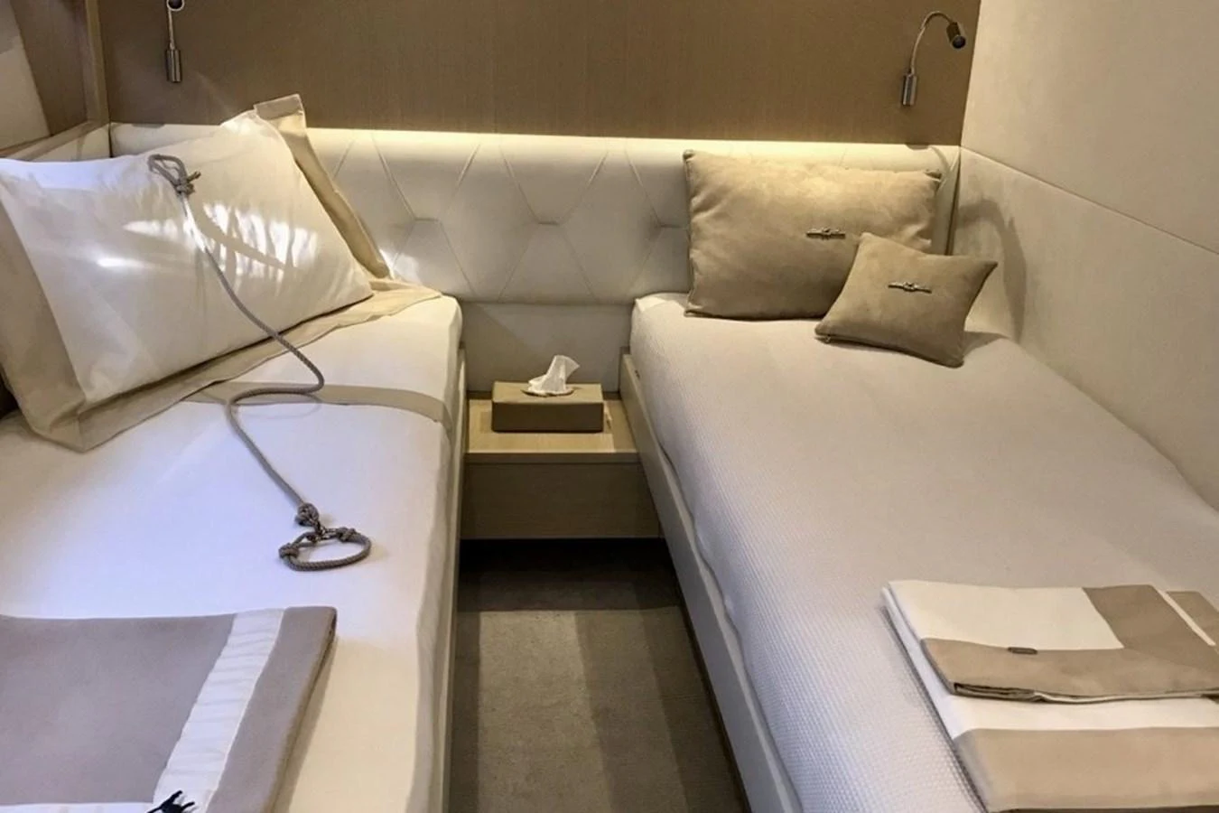 A cozy twin stateroom with elegant bedding and soft lighting. aboard MS FELICE Yacht for Sale
