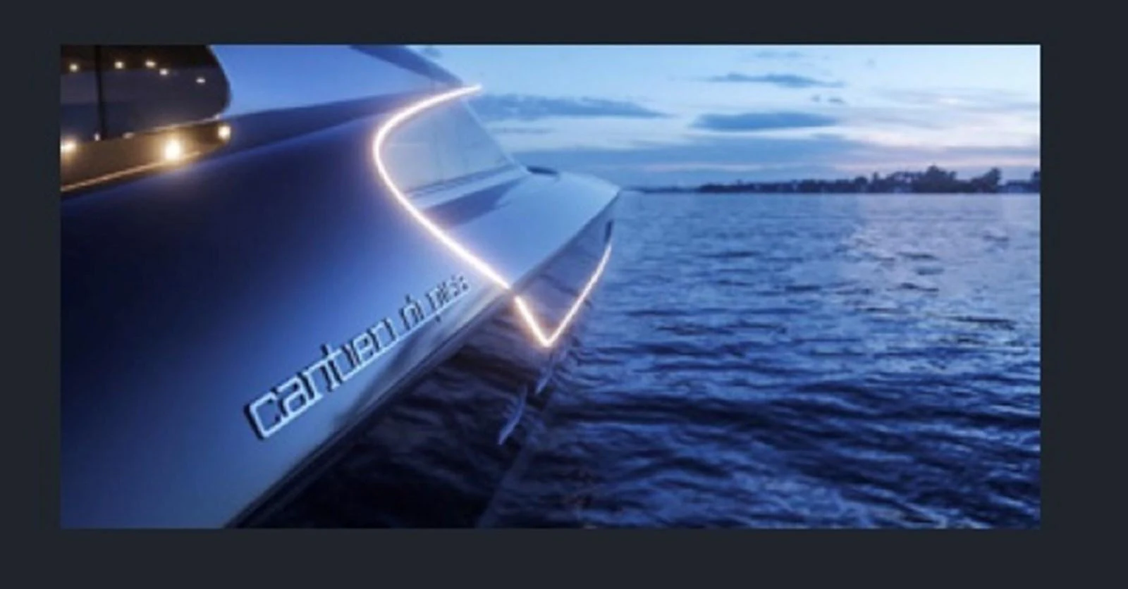 A sleek yacht glides through the water at dusk, illuminated by elegant lighting. aboard OTTANTA VELOCE Yacht for Sale