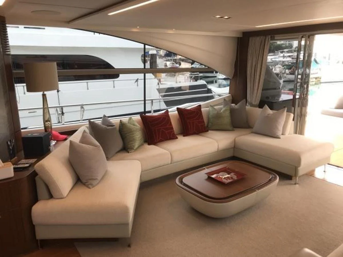 The salon features a spacious and elegant seating area with large windows offering a view of the marina. aboard ANDAMAN PRINCESS Yacht for Sale