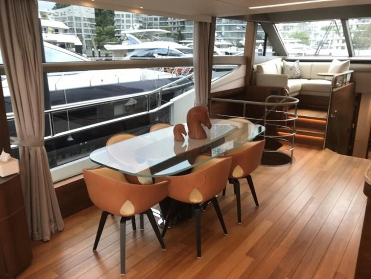 The yacht's dining area features a sleek glass table with stylish chairs, offering a modern and inviting space for meals. aboard ANDAMAN PRINCESS Yacht for Sale