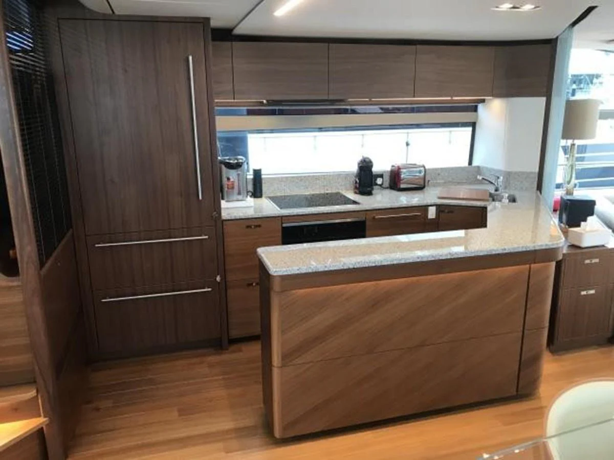 The yacht's galley features modern wooden cabinetry and sleek countertops, creating a stylish and functional space for meal preparation. aboard ANDAMAN PRINCESS Yacht for Sale