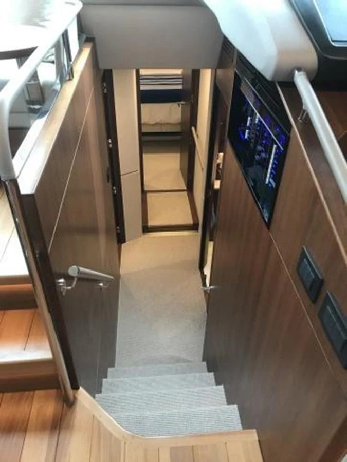 A well-lit stairway leads to the lower deck, showcasing the yacht's elegant interior design. aboard ANDAMAN PRINCESS Yacht for Sale