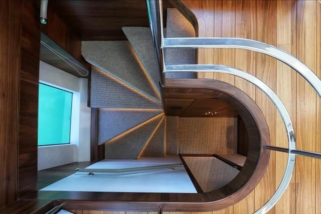 A beautifully crafted wooden staircase with modern railings leads to the lower deck. aboard ANDAMAN PRINCESS Yacht for Sale