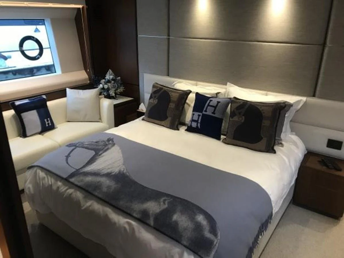 A luxurious stateroom featuring a comfortable bed with elegant bedding and a cozy seating area. aboard ANDAMAN PRINCESS Yacht for Sale