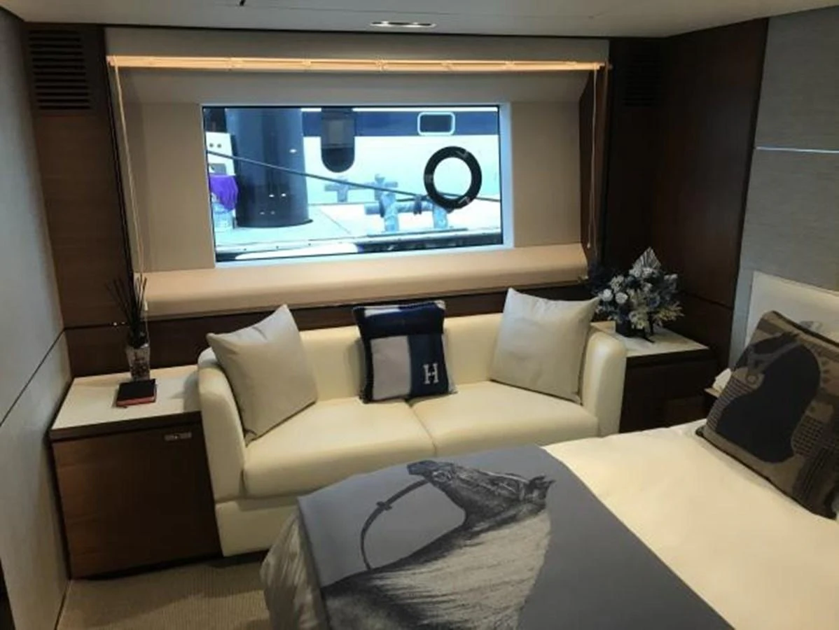 The stateroom features a cozy seating area and a large bed with elegant decor. aboard ANDAMAN PRINCESS Yacht for Sale