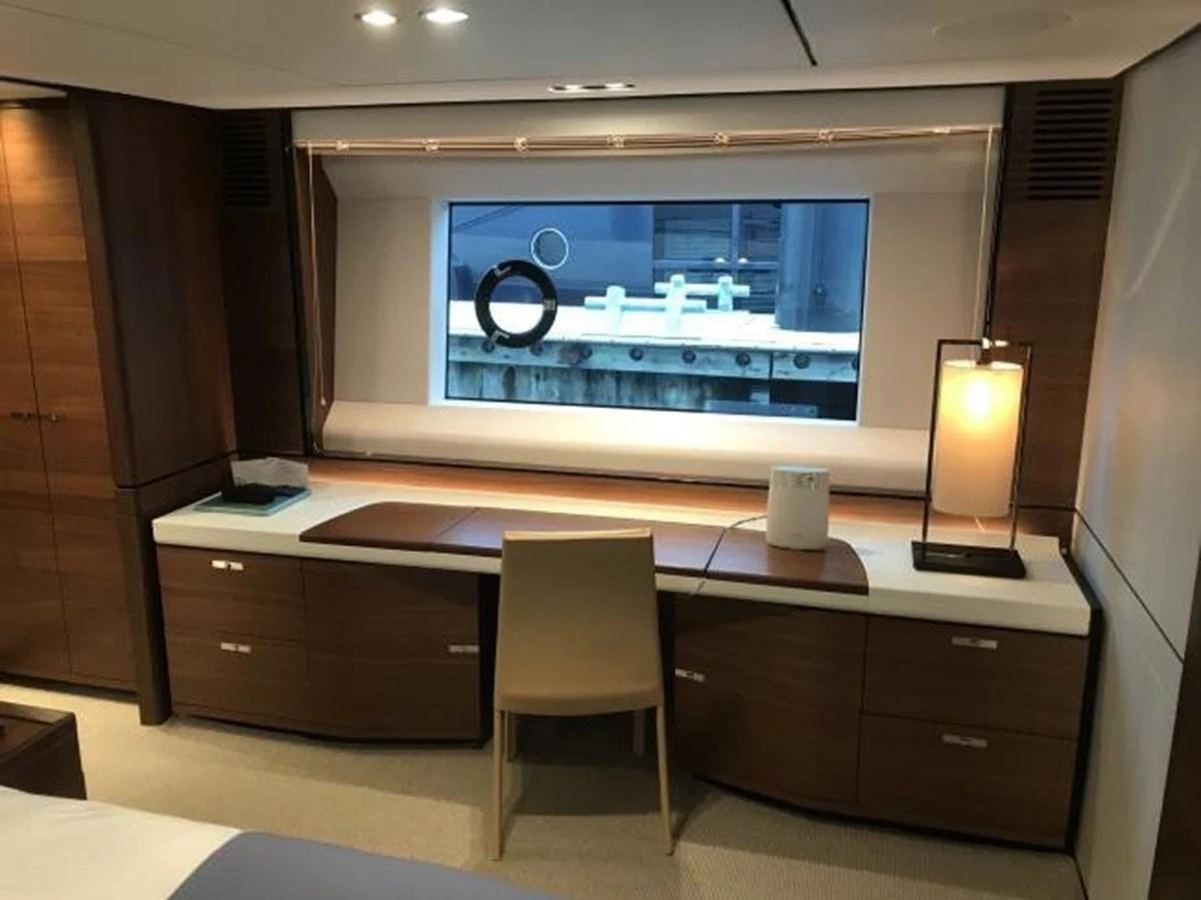 The stateroom features a sleek desk area with a large window providing natural light. aboard ANDAMAN PRINCESS Yacht for Sale