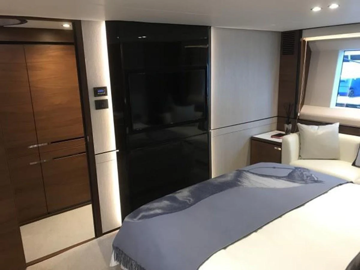 A luxurious stateroom featuring a large bed, modern furnishings, and a flat-screen TV. aboard ANDAMAN PRINCESS Yacht for Sale