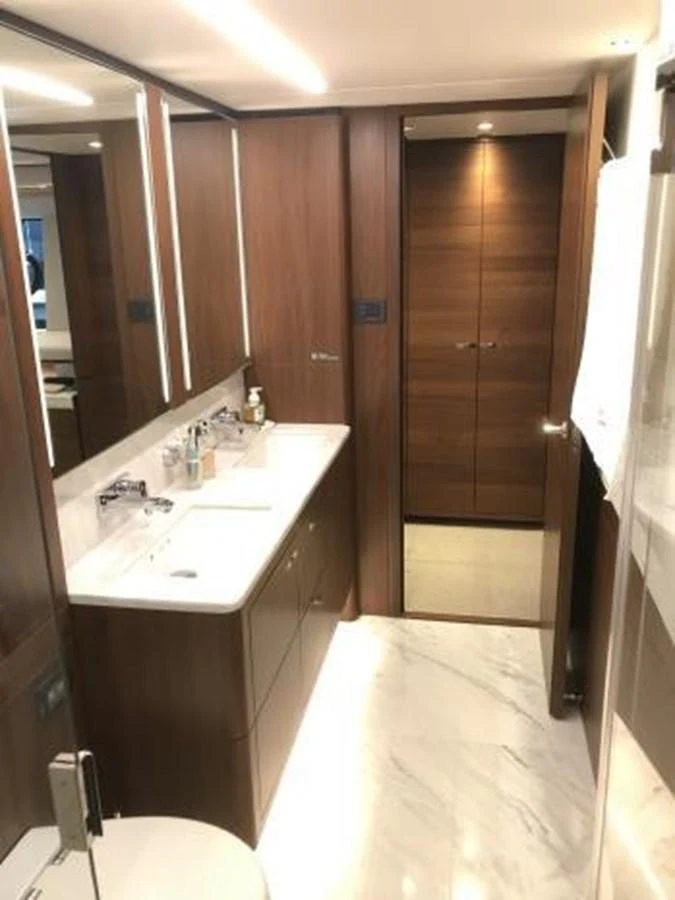 The yacht's bathroom features elegant wood paneling and a sleek marble countertop. aboard ANDAMAN PRINCESS Yacht for Sale