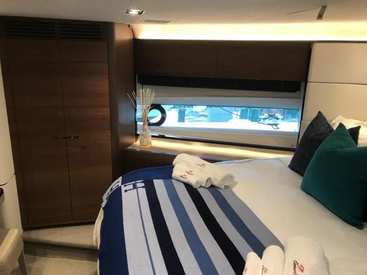 A cozy stateroom featuring a comfortable bed with stylish linens and a large window for natural light. aboard ANDAMAN PRINCESS Yacht for Sale