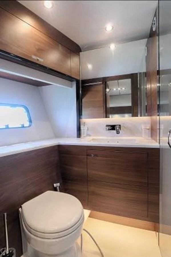 The yacht's bathroom features sleek wooden cabinetry and modern fixtures. aboard ANDAMAN PRINCESS Yacht for Sale
