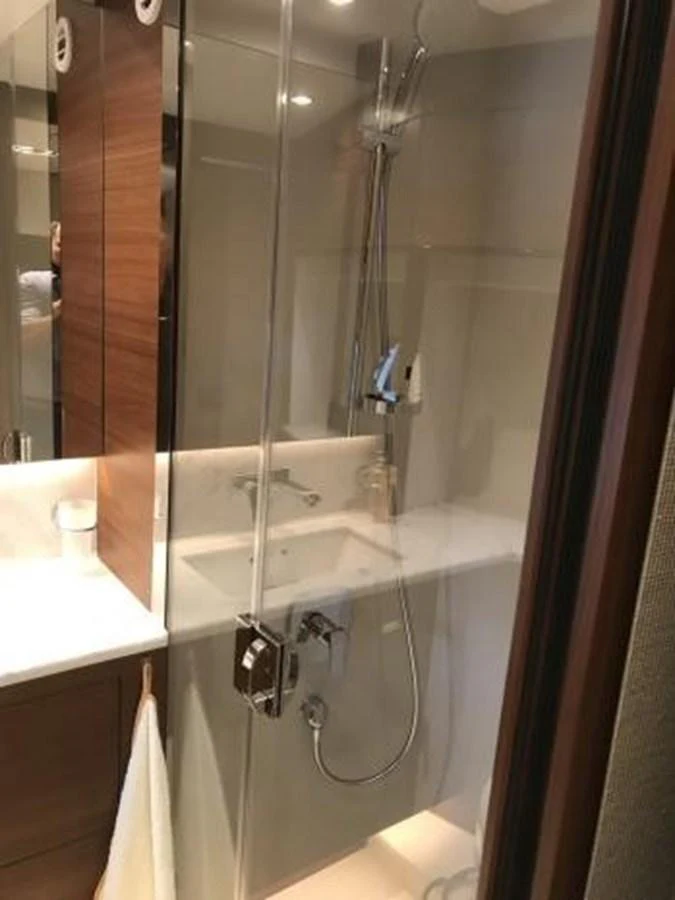 A sleek and modern bathroom with a glass-enclosed shower and elegant fixtures. aboard ANDAMAN PRINCESS Yacht for Sale