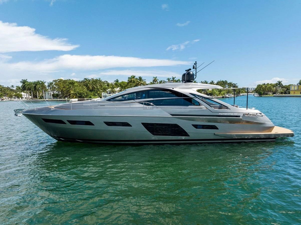 A sleek and modern yacht glides gracefully on calm waters under a clear blue sky. aboard QUANTUM Yacht for Sale