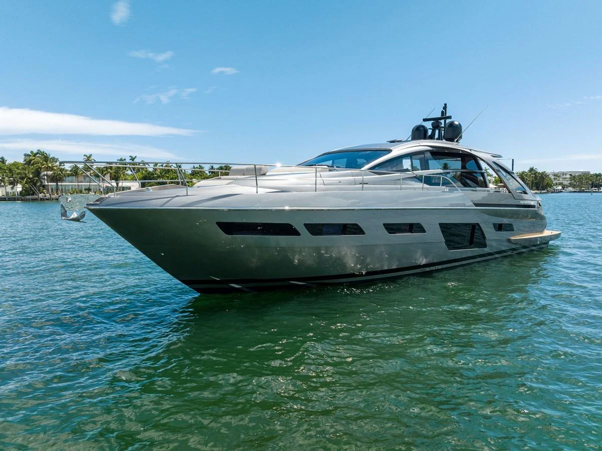 A sleek and modern yacht glides through calm waters under a clear blue sky. aboard QUANTUM Yacht for Sale