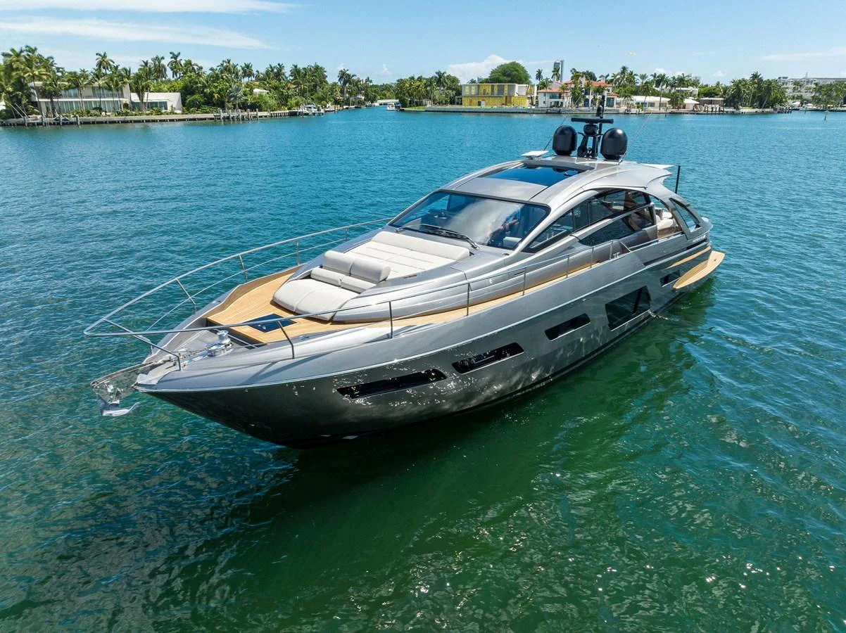 A sleek and modern yacht cruising on calm waters near a tropical shoreline. aboard QUANTUM Yacht for Sale