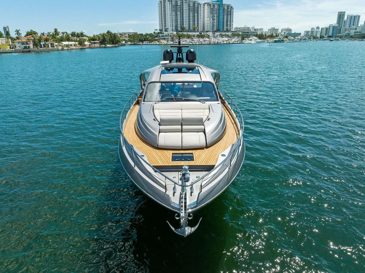A sleek yacht cruising in a calm, urban waterfront setting. aboard QUANTUM Yacht for Sale
