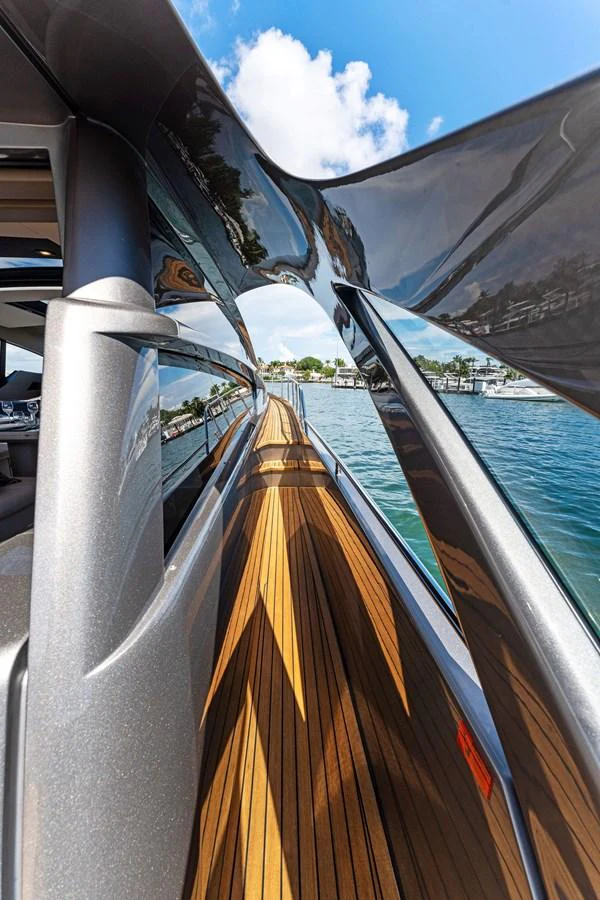 A sleek and modern yacht walkway with polished surfaces and wooden decking. aboard QUANTUM Yacht for Sale