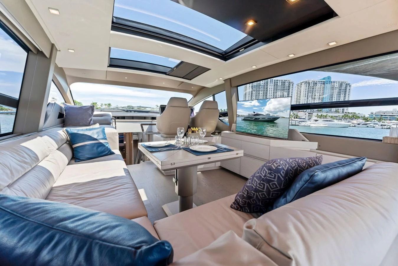 The salon features spacious seating with large windows and a skylight offering stunning views. aboard QUANTUM Yacht for Sale
