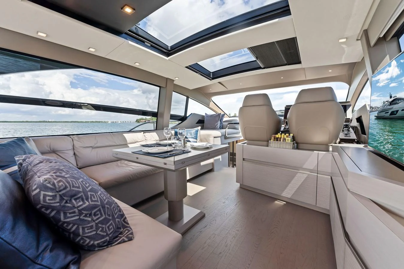 The salon features elegant seating and a dining area with panoramic views. aboard QUANTUM Yacht for Sale