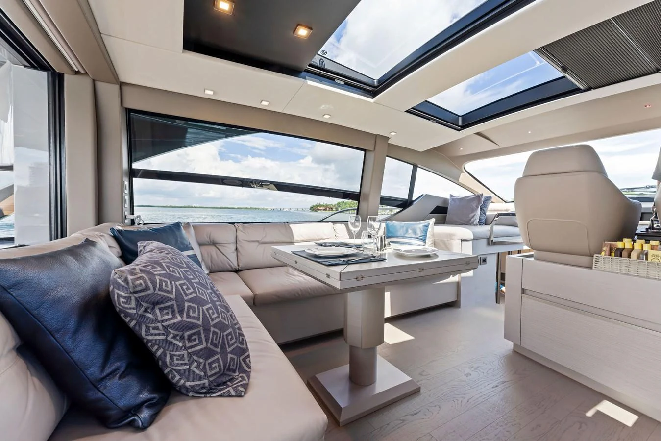 The salon features luxurious seating and large windows for stunning views. aboard QUANTUM Yacht for Sale