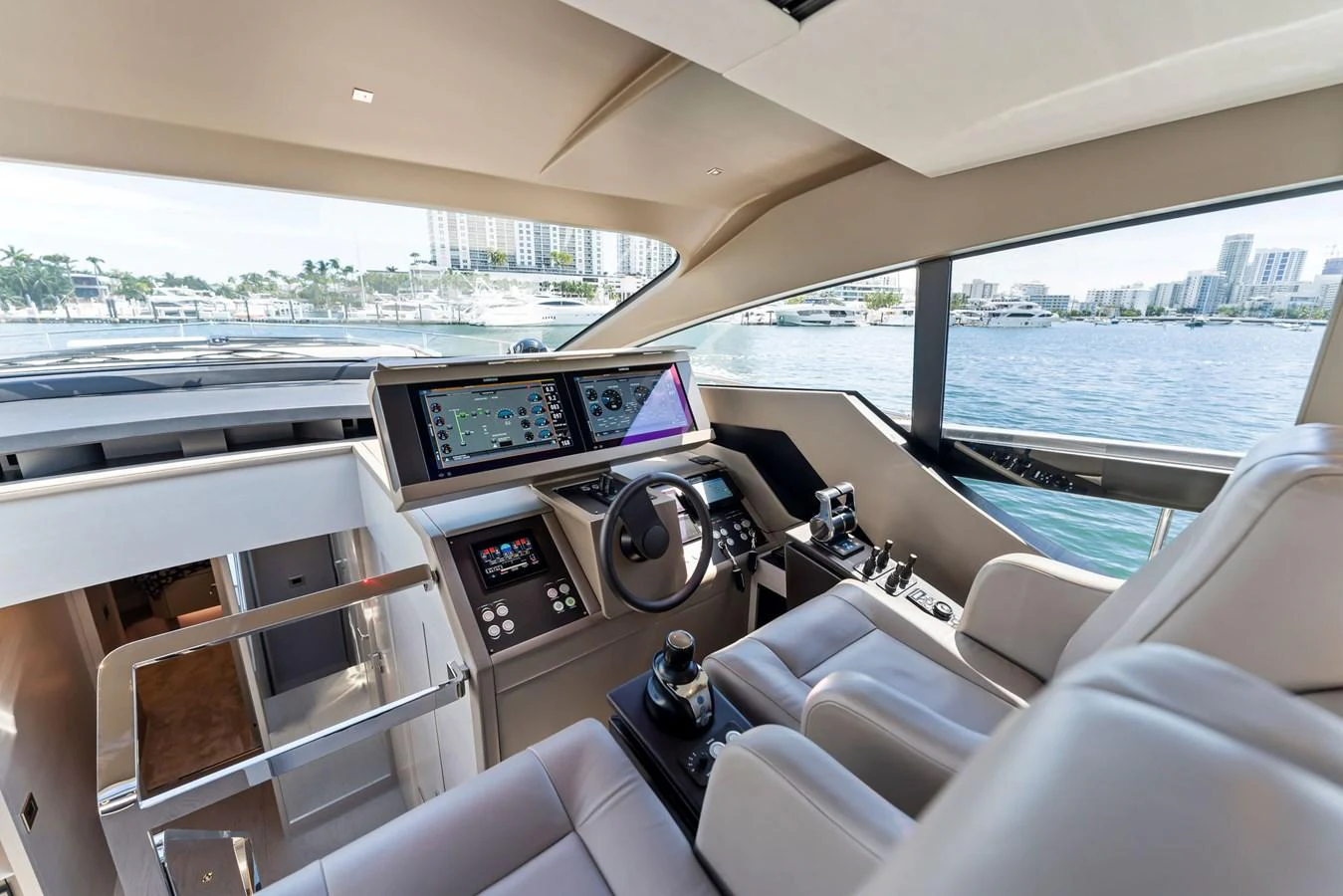 The helm features modern navigation equipment and comfortable seating with a panoramic view. aboard QUANTUM Yacht for Sale