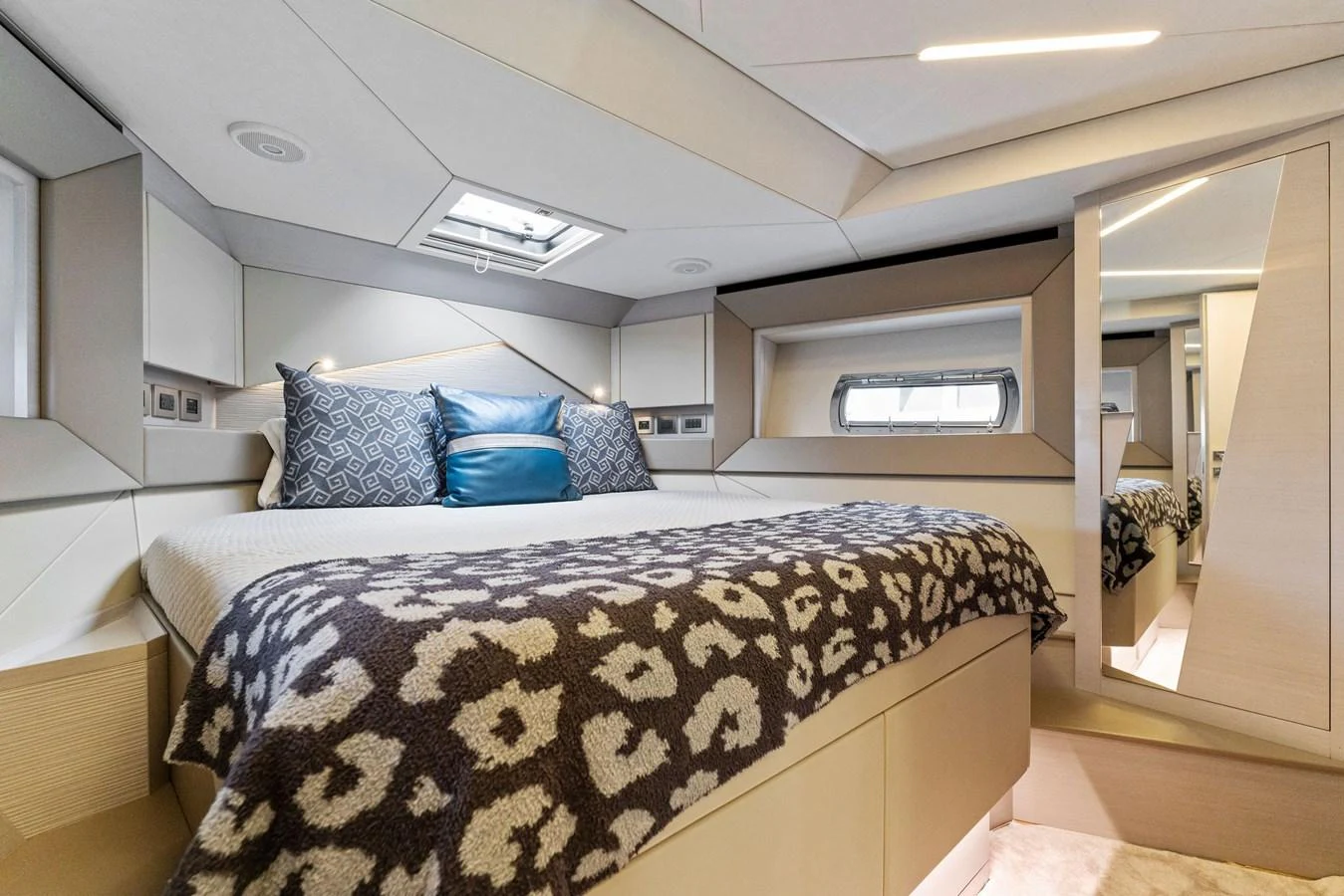 A luxurious stateroom featuring a comfortable bed with elegant bedding and modern design elements. aboard QUANTUM Yacht for Sale