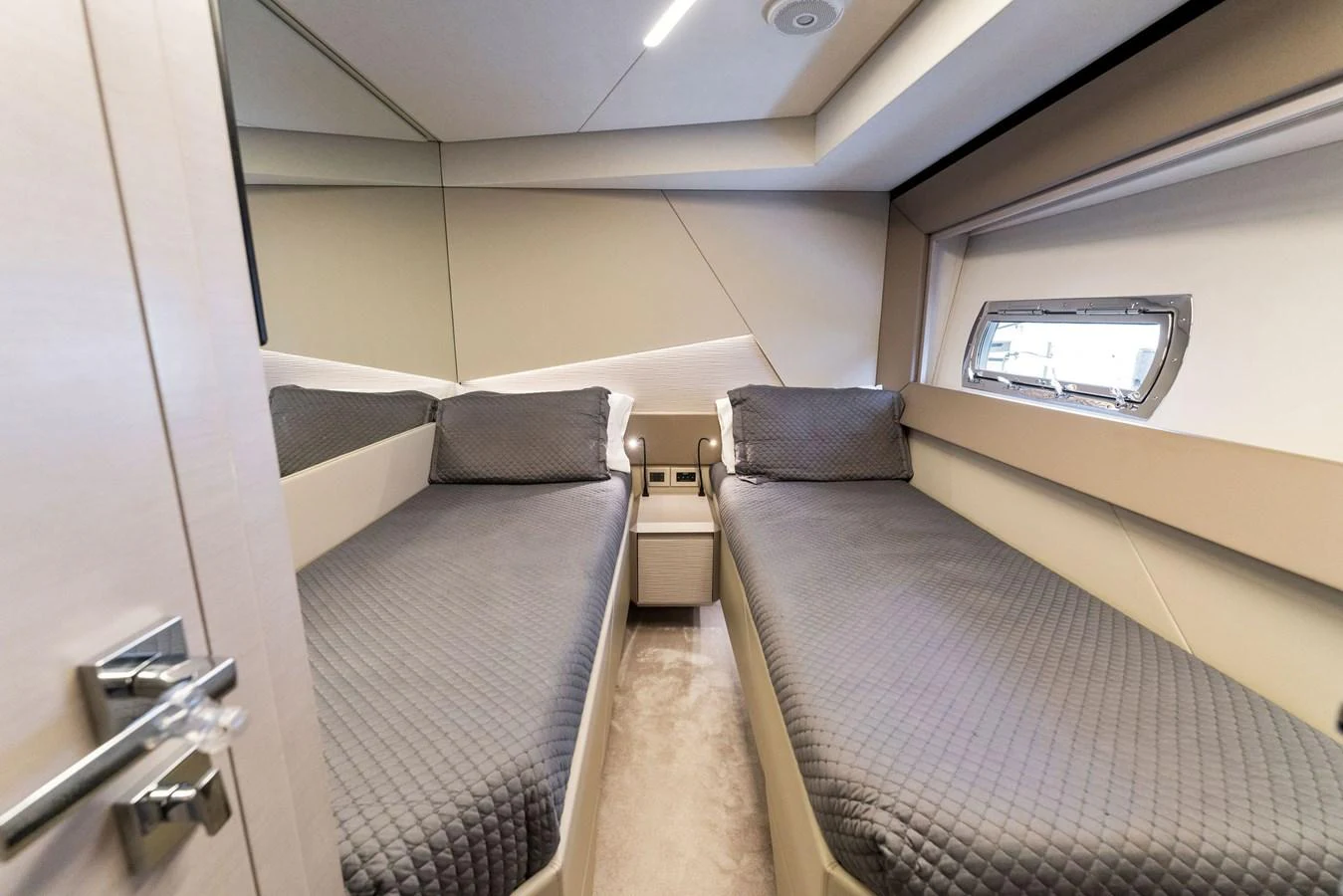 The guest stateroom features twin beds with modern decor and ample natural light. aboard QUANTUM Yacht for Sale