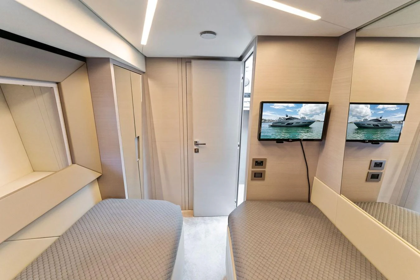 A modern guest cabin featuring twin beds and a flat-screen TV. aboard QUANTUM Yacht for Sale