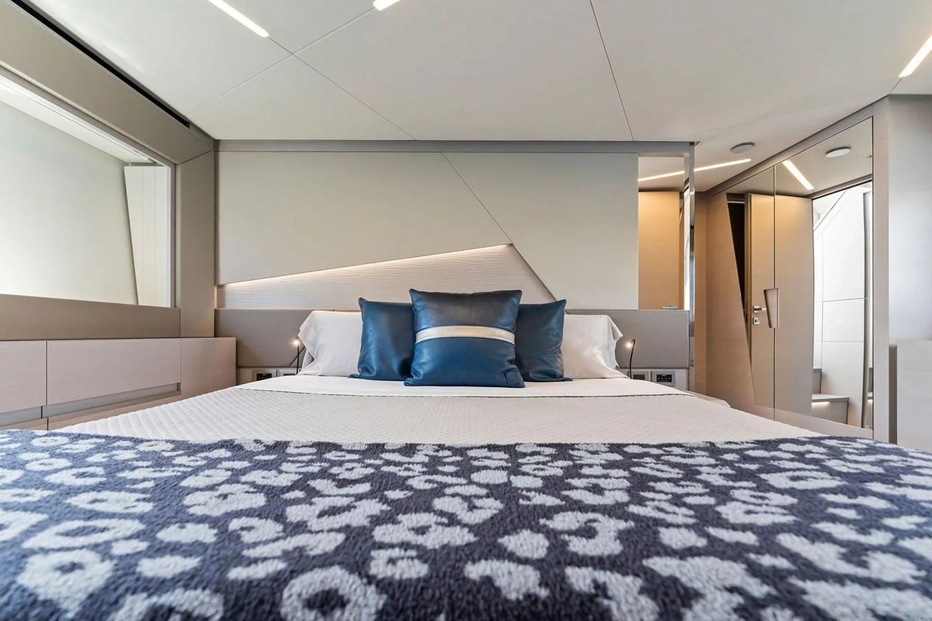 A luxurious stateroom featuring a comfortable bed with elegant bedding and modern design elements. aboard QUANTUM Yacht for Sale