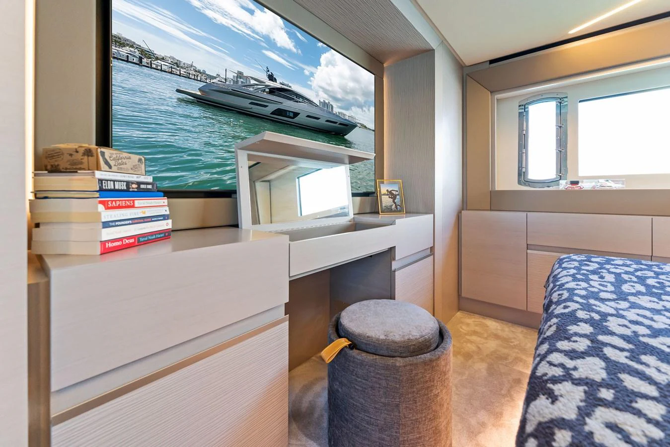 A cozy stateroom featuring a television, books, and a comfortable seating area. aboard QUANTUM Yacht for Sale