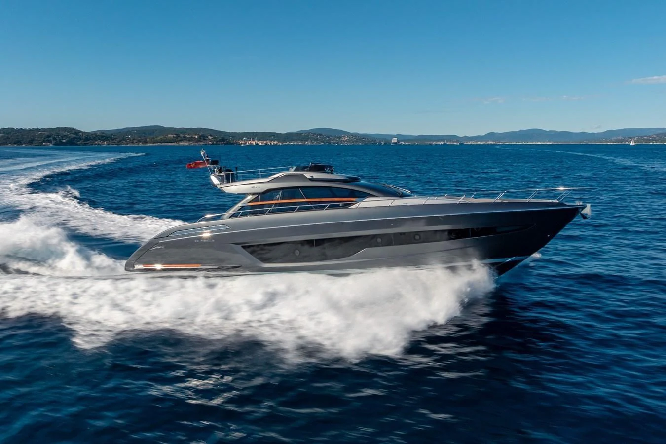 A sleek and modern yacht glides swiftly through the open water, showcasing its elegant design. aboard AMELIA Yacht for Sale