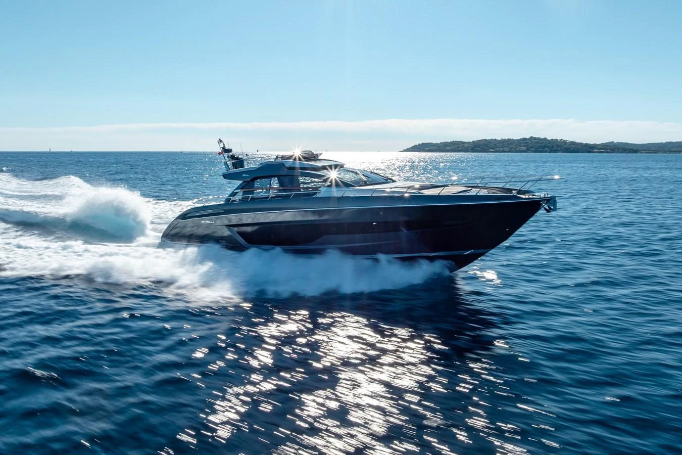 A sleek yacht glides swiftly across the open sea under a clear blue sky. aboard AMELIA Yacht for Sale