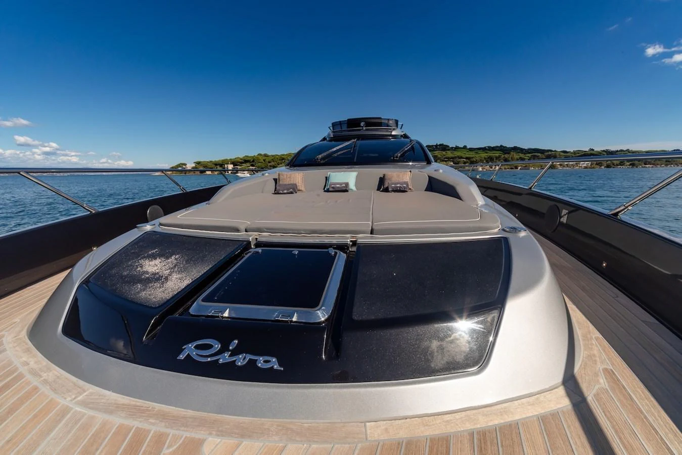 The yacht's sleek bow area features luxurious sun pads under a clear blue sky. aboard AMELIA Yacht for Sale