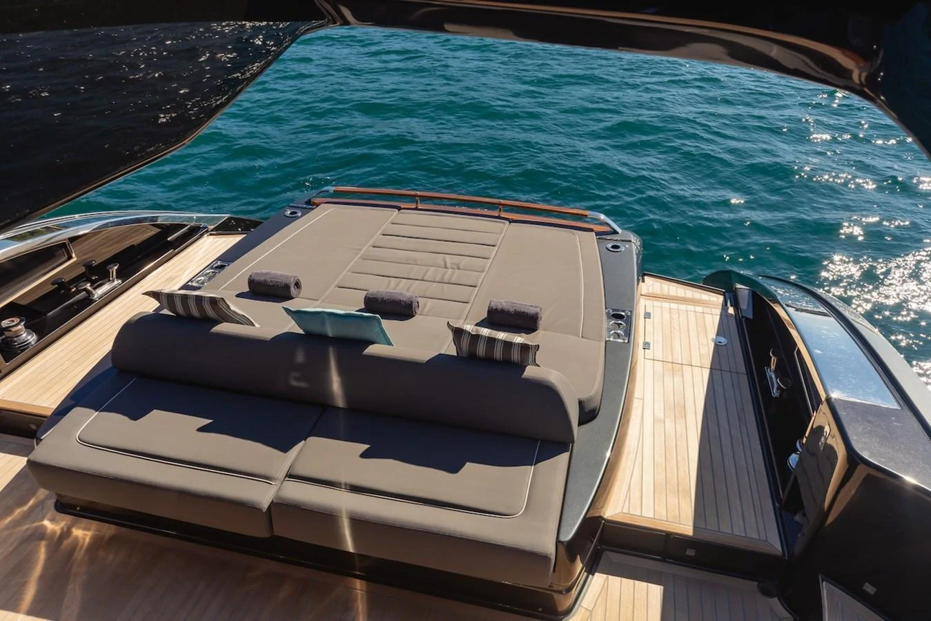 The aft deck features a luxurious sunbed with a stunning view of the water. aboard AMELIA Yacht for Sale