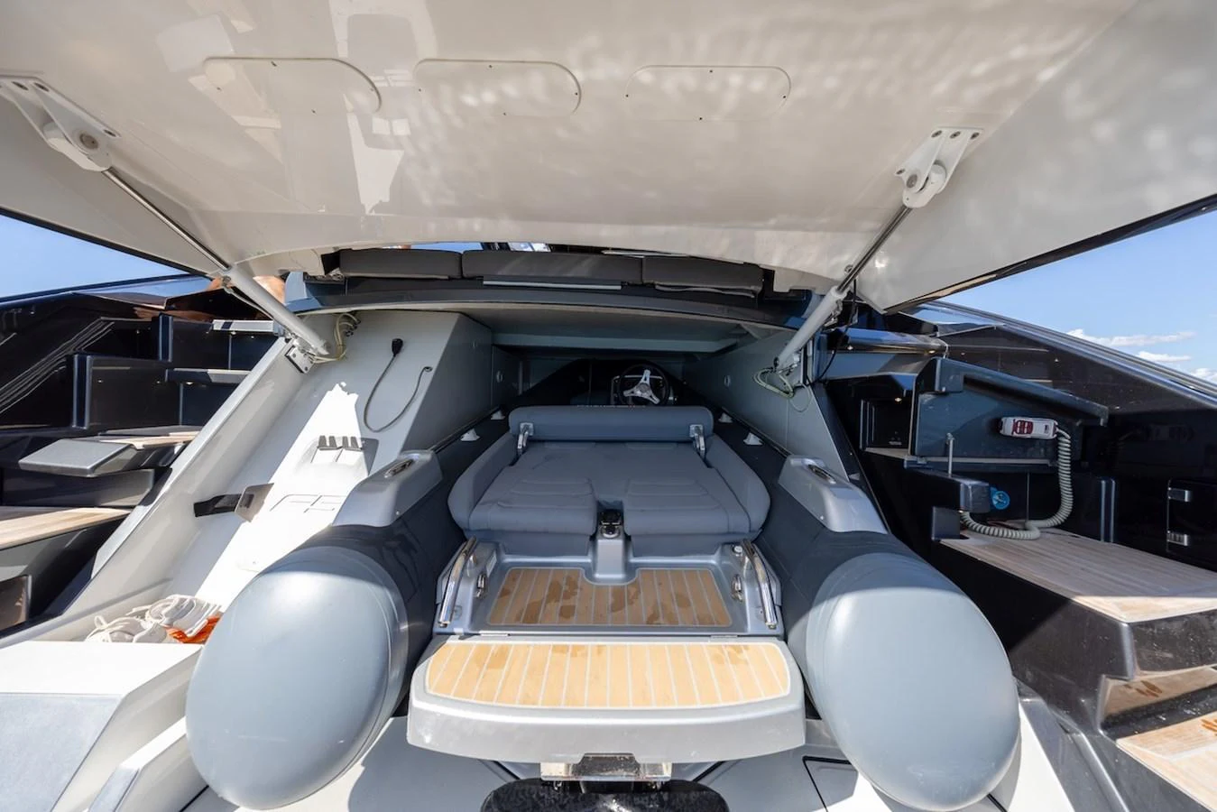 A sleek tender is stored in a dedicated compartment on the yacht, ready for deployment. aboard AMELIA Yacht for Sale