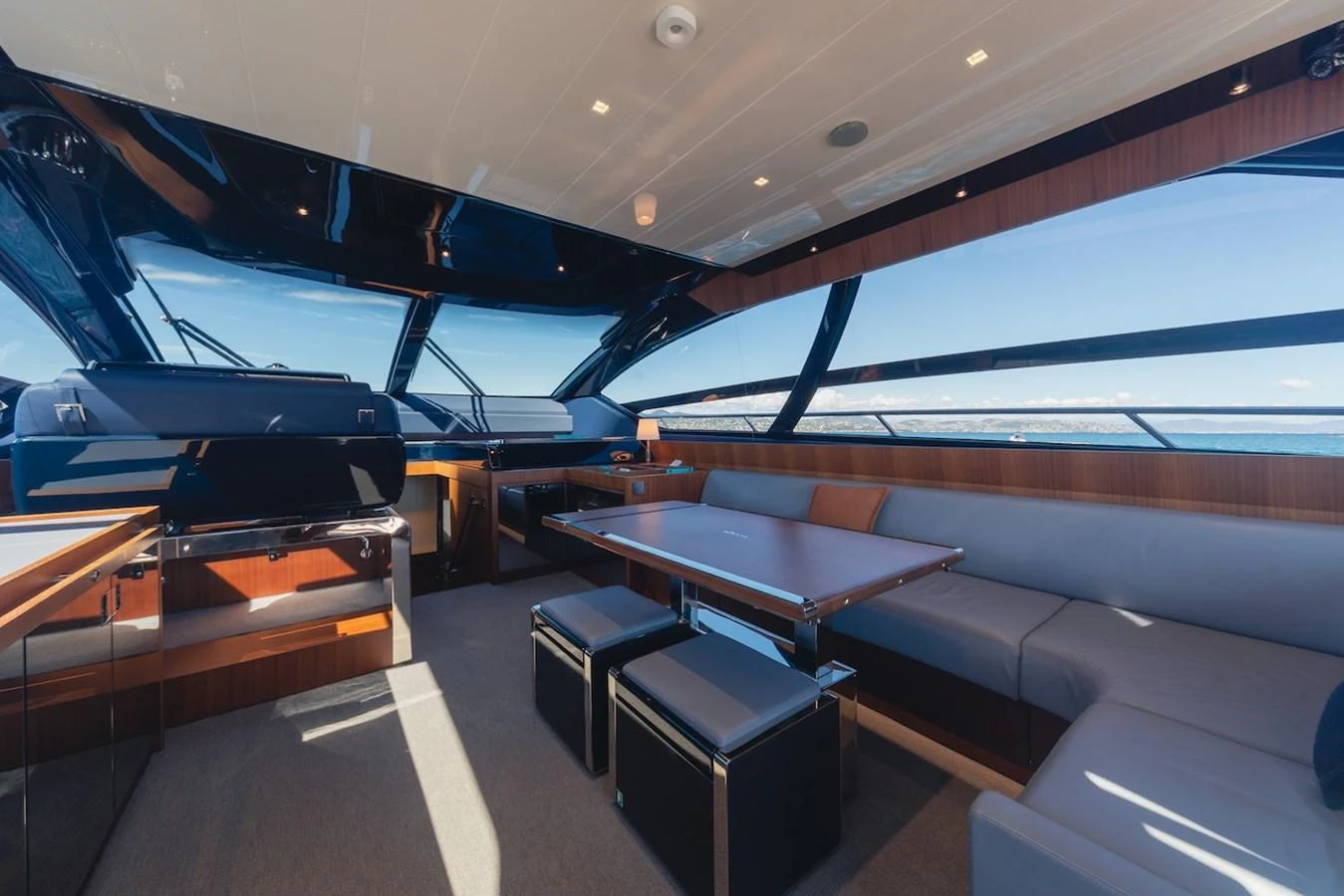 The salon features a spacious seating area with panoramic windows offering stunning sea views. aboard AMELIA Yacht for Sale