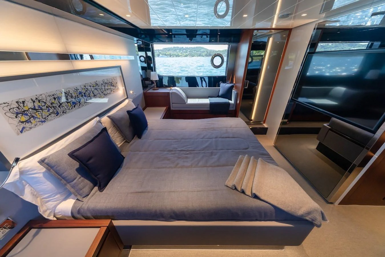 The stateroom features a luxurious bed with plush pillows and a modern, stylish decor. aboard AMELIA Yacht for Sale
