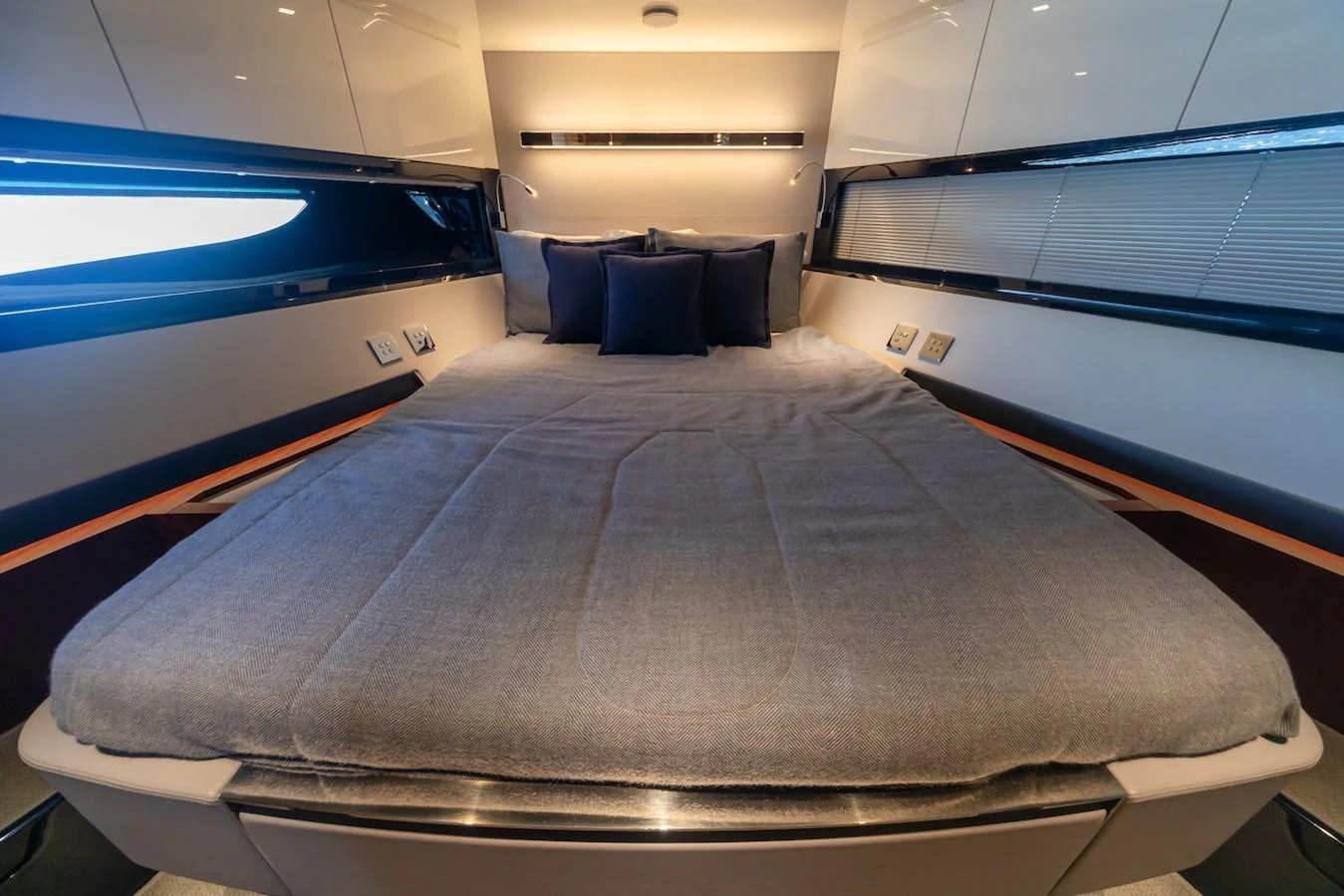 The stateroom features a plush bed with elegant lighting and modern design elements. aboard AMELIA Yacht for Sale