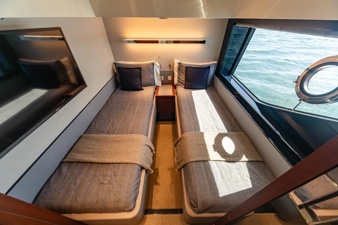 The twin stateroom features two comfortable beds with a view of the sea through a large window. aboard AMELIA Yacht for Sale