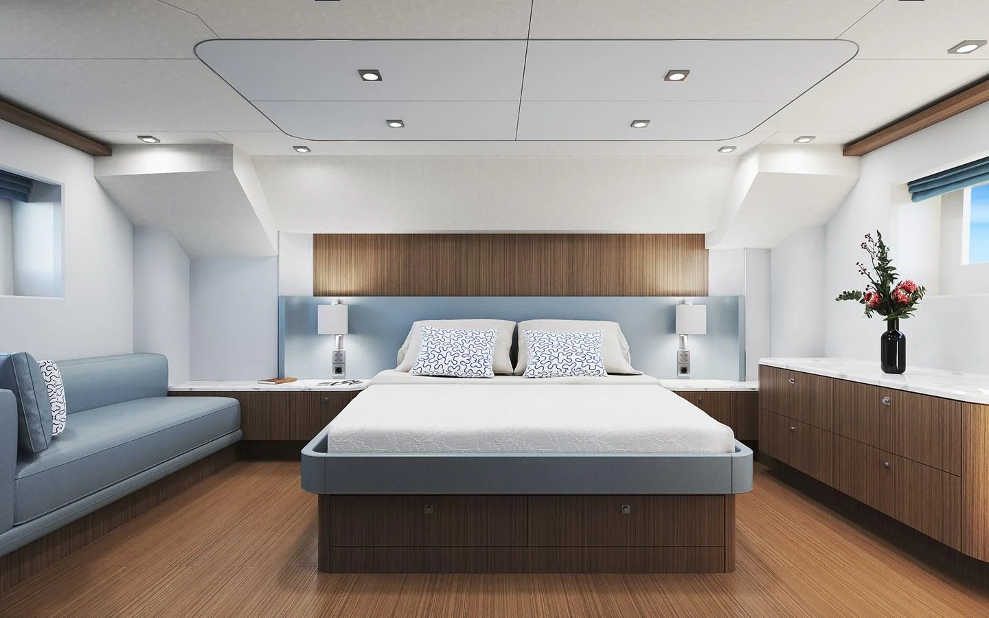 The master stateroom features a spacious bed, elegant wood finishes, and modern lighting. aboard TBD Yacht for Sale