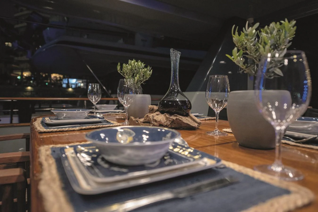 An elegant dining area set for a refined meal, featuring stylish tableware and ambient lighting. aboard KISS Yacht for Sale