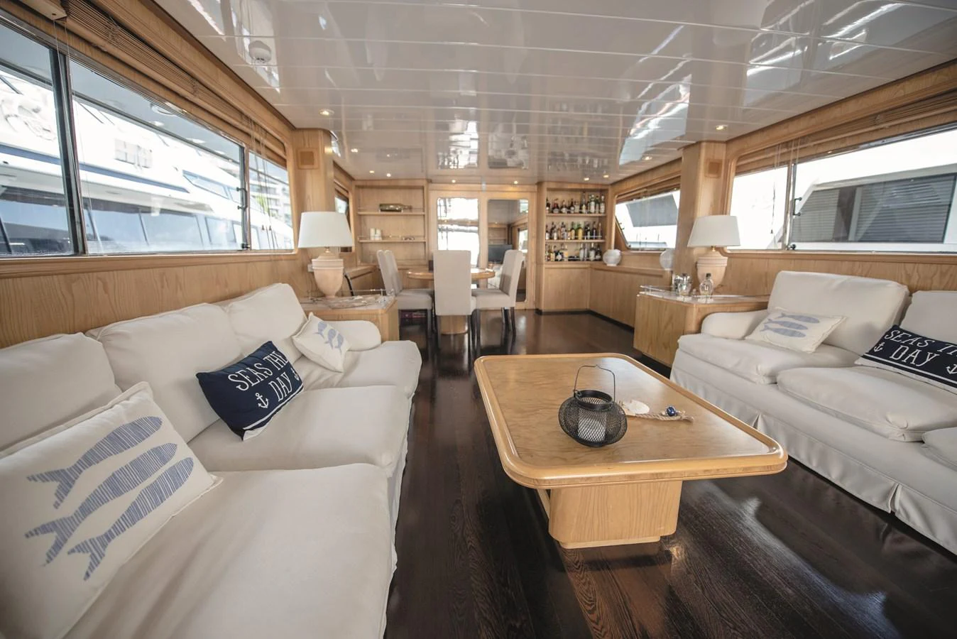 The yacht's salon features plush seating, elegant decor, and ample natural light. aboard KISS Yacht for Sale